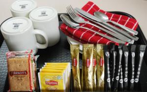 a table with utensils and a plate of food at Mayfair Motel in West Wyalong