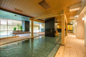 an indoor pool in a building with a ceiling at Kinugawa Onsen Hotel in Nikko