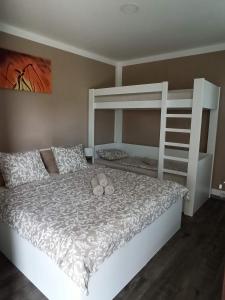 a bedroom with two bunk beds with shoes on the bed at Za Humnama in Hlohovec