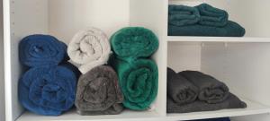 a bunch of towels sitting on a shelf at Appart détente à 200m de la Plage in Le Grau-du-Roi +21 photos