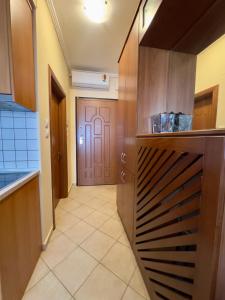 a hallway leading to a kitchen with a door at Family Beach apartment in Perea