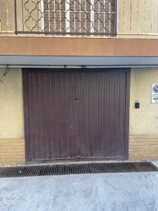 a brown garage door on the side of a building at Casa Viola vicino al mare by SMART-HOME in Vallecrosia
