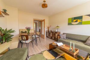 a living room with a couch and a table at Erzgebirge Suite Gipfelgrün in Kurort Oberwiesenthal