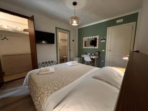 a bedroom with a large bed and a table at Affittacamere Il Cuore Verde in Norcia