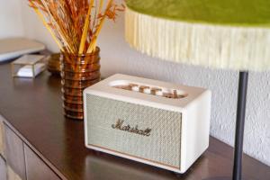 a small white radio sitting on top of a table at Erzgebirge Suite Gipfelgrün in Kurort Oberwiesenthal +9 photos