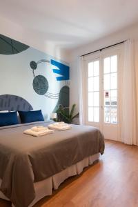 a bedroom with a bed with two towels on it at Fliphaus Mansion Paz B - 10 pax Deluxe House Belgrano in Buenos Aires