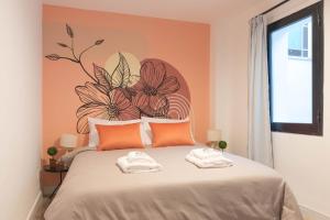 a bedroom with a bed with a flower mural on the wall at Fliphaus Mansion Paz B - 10 pax Deluxe House Belgrano in Buenos Aires