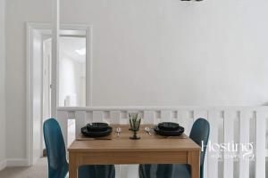 a dining room table with blue chairs and a wooden table at Fairmile Loft - Cosy 1-Bed Stay in Central Henley in Henley on Thames