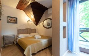 a bedroom with a bed and a large window at Willa Ahava in Kazimierz Dolny