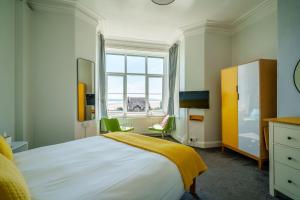 a bedroom with a large bed and a window at Corner Beech House in Grange Over Sands