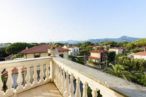 a balcony with a view of a city at GOLDEN LUXE - Royal Sea View Private Parking in Marina di Pietrasanta