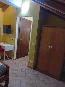 Camera con porta, tavolo e scrivania. di Casa Happy - La mansarda del sorriso con parcheggio privato a Valcorrente a Belpasso