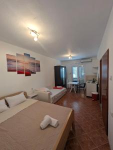 a bedroom with two beds and a living room at Matovic Apartments in Dobra Voda