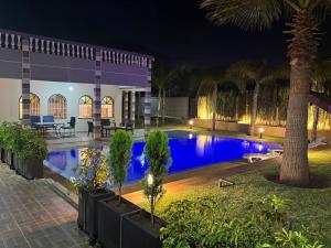 a house with a swimming pool at night at Villa Ines avec piscine privée in Sidi Moussa Ben Ali