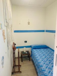 a bedroom with a blue bed and a table at La Casetta di Nico in Beverone +13 photos