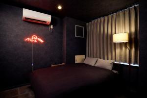 a bedroom with a bed and a air conditioner on the wall at Hotel-Mercurius-Azabujuban-RB in Tokyo