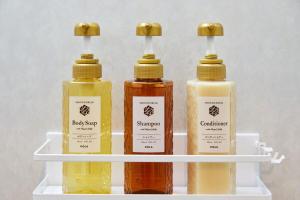 three bottles of soap sitting on a shelf at Hotel-Mercurius-Azabujuban-RB in Tokyo