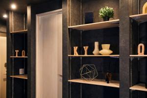 a room with black walls and shelves with vases at Hotel-Mercurius-Azabujuban-RB in Tokyo