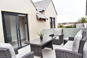 a patio with a table and chairs on a balcony at Stella Maris #4 Self-catering in Swakopmund