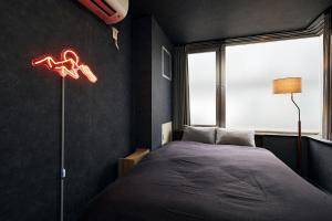 a bedroom with a bed and a window at Hotel-Mercurius-Azabujuban-RB in Tokyo