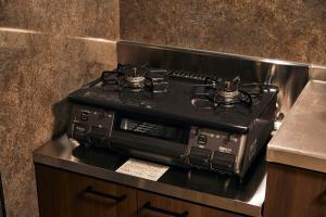 a gas stove sitting on top of a counter at Hotel-Mercurius-Azabujuban-RB in Tokyo
