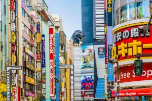 a busy city street with many signs and buildings at Hotel-Mercurius-Azabujuban-RB in Tokyo