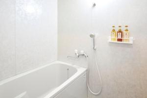 a white bathroom with a shower and a bath tub at Hotel-Mercurius-Azabujuban-RB in Tokyo +37 photos