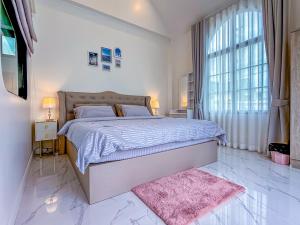 a bedroom with a large bed and a pink rug at N&C Mountain Pool Villa Huahin in Hua Hin +42 photos