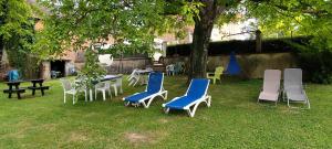 a group of chairs and tables in a yard at Notre Doux Logis in Les Bordes