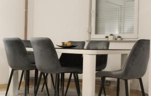 a dining room table with four chairs around it at Wildlight in Bihać