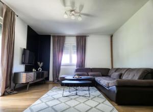 a living room with a couch and a table at Wildlight in Bihać +14 photos