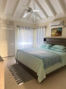 a bedroom with a bed with a ceiling fan at Luxury villas Oceanic View - Richmond Estate in Richmond +54 photos
