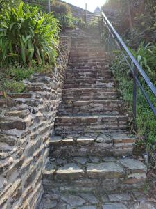 a set of stone stairs next to a fence at Maison de charme cancalaise in Cancale
