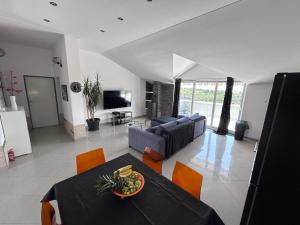 a living room with a table and a couch at Holiday home Lucas with pool in Buzdohanj