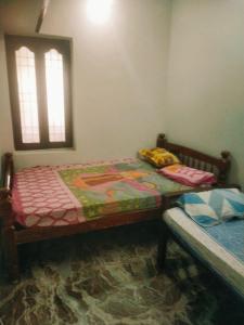 a bedroom with two twin beds and a window at Villa Butterfly Studio in Pondicherry +3 photos