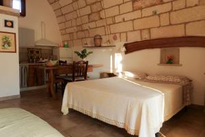 Postel nebo postele na pokoji v ubytování Palacca, trullo salentino