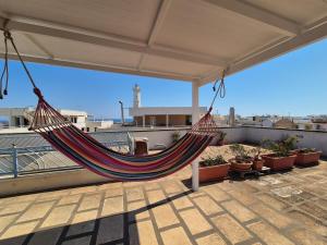 a hammock on the roof of a house at CasAMiCa in Torre Canne