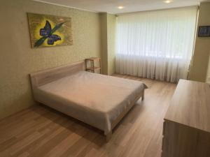 a small bedroom with a bed and a window at Soldino Apartments in Narva +5 photos