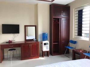 a room with a bedroom with a bed and a mirror at Lao Cai Sun Hotel in Cốc Lếu