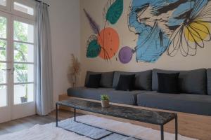 a living room with a couch and a table at Fliphaus Niceto Vega 4900 - 3 Bd Event & Party Friendly in Buenos Aires