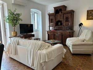 a living room with a white couch and a tv at BAKITA in Rijeka