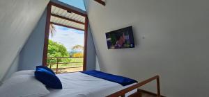a bedroom with a bed with a view of a window at Finca el diamante in Villavicencio +9 photos
