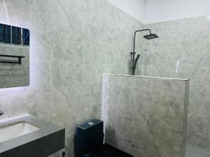 a bathroom with a sink and a shower and a tub at A Royal Glamourous Apartment in Mwombali +25 photos