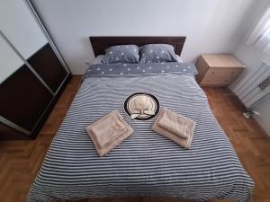 a bed with two pillows on it in a room at Amar6 in Novi Beograd