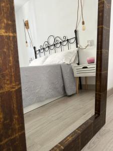 a bedroom with a bed and a table with a mirror at La Casita del abuelo Javi in Cambados +34 photos