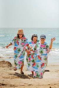 a group of three women walking on the beach at Blue Apple Beach in Tierra Bomba