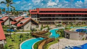 an aerial view of a resort with two pools at Oka Beach Residence Muro Alto in Cupe