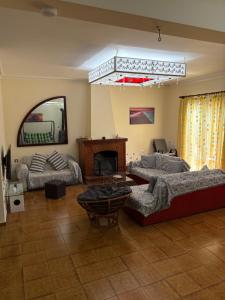 a living room with a couch and a fireplace at HeidiHouse in Patra +24 photos