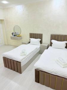 two beds in a room with two beds sidx sidx sidx sidx at Home Hotel in Toshkent-Passajir Bekati