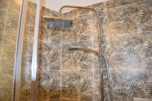 una doccia in bagno con parete a motivi geometrici di Eden Borbonico a Caserta Altre 42 foto